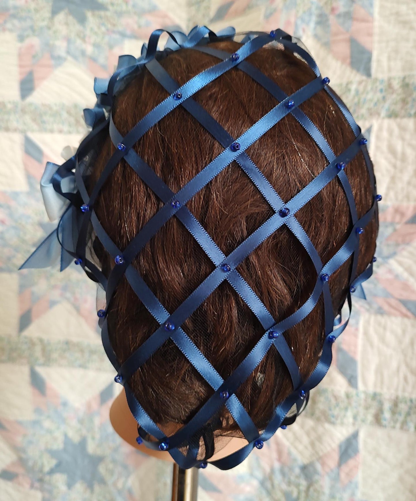 back view of navy ribbon hairnet showing satin ribbon and beading