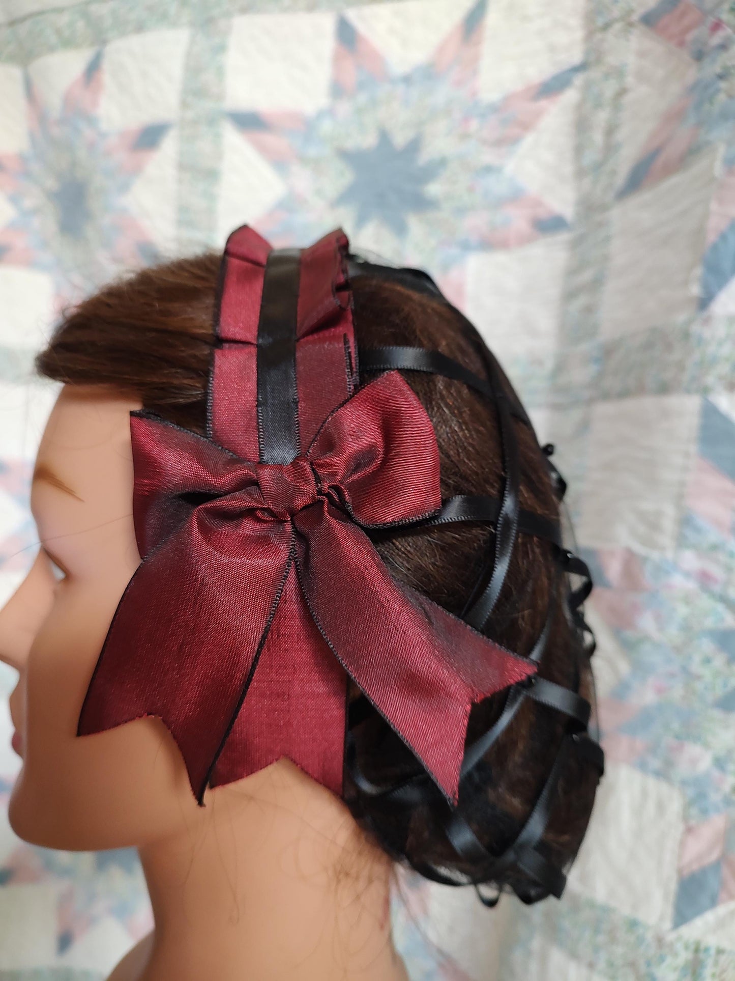side view of burgandy coronet showing the black ribbon