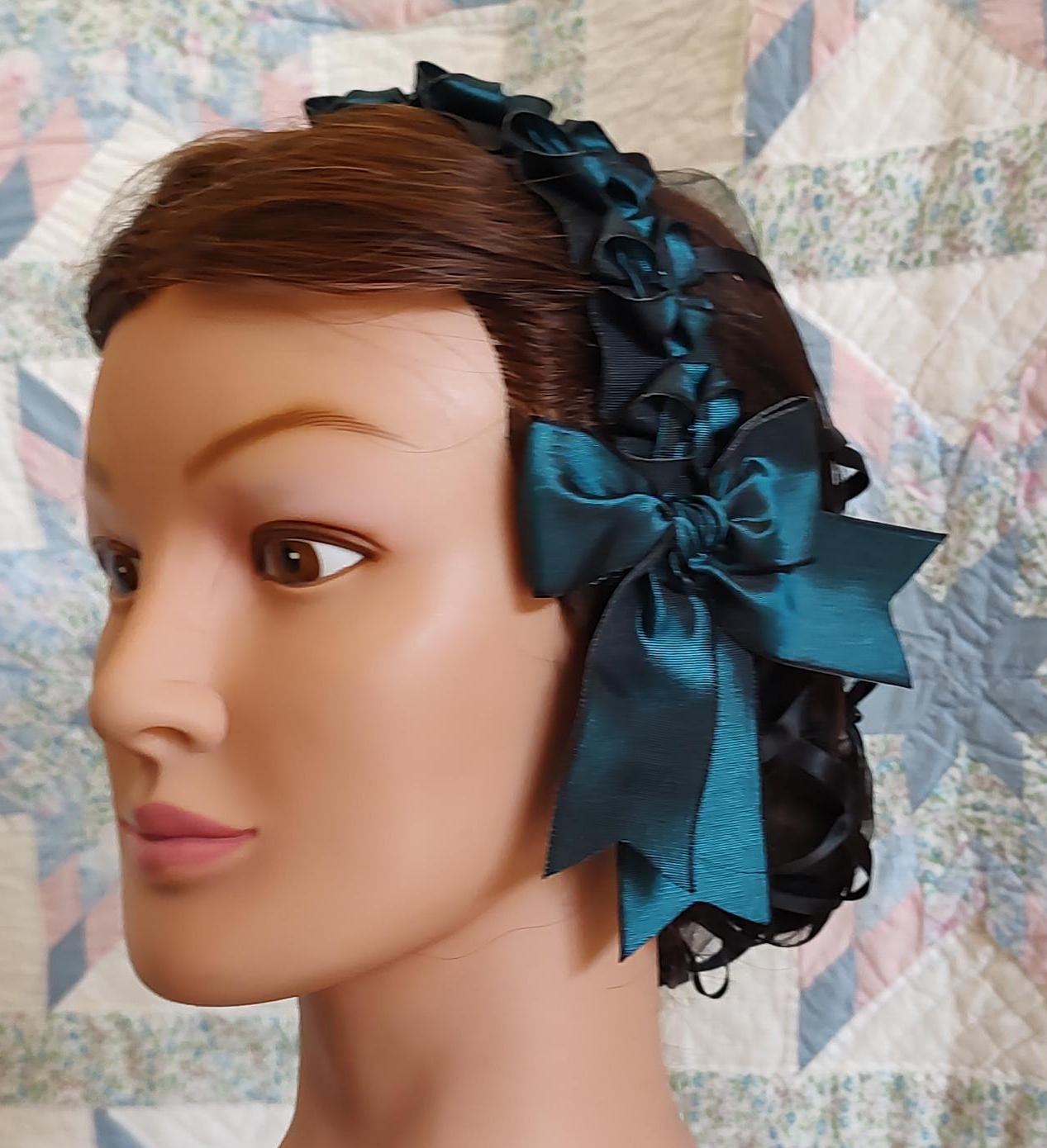 side to front view of teal coronet